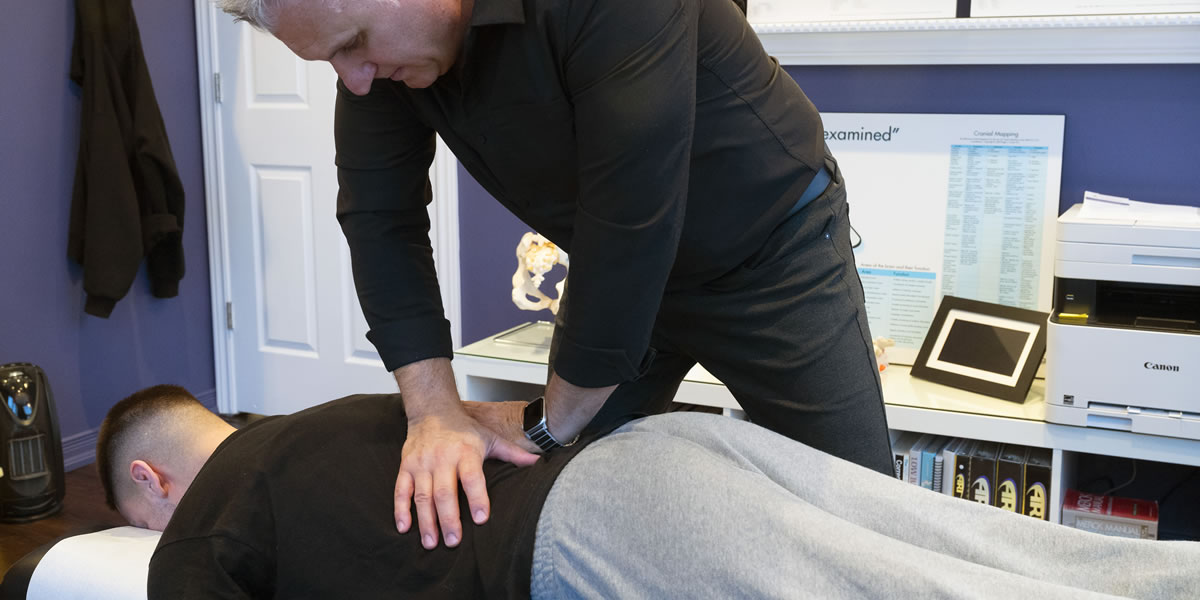 Dr. Varga adjusting a patient's lower back.