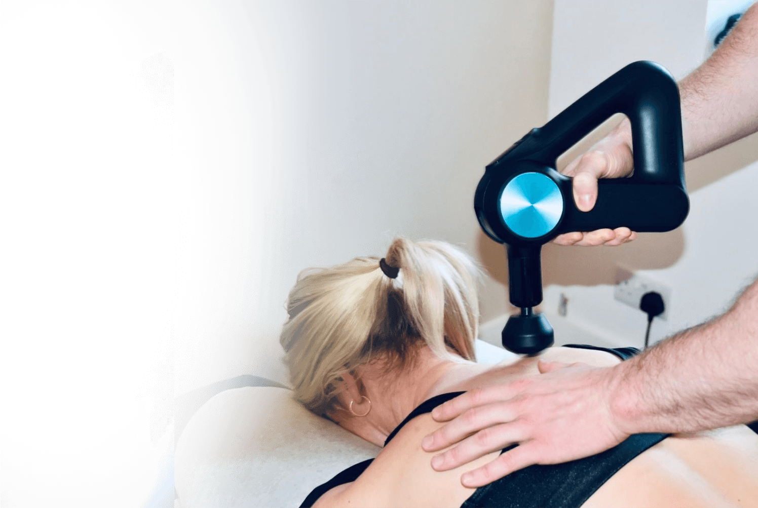 Massaging tool being used on patients back