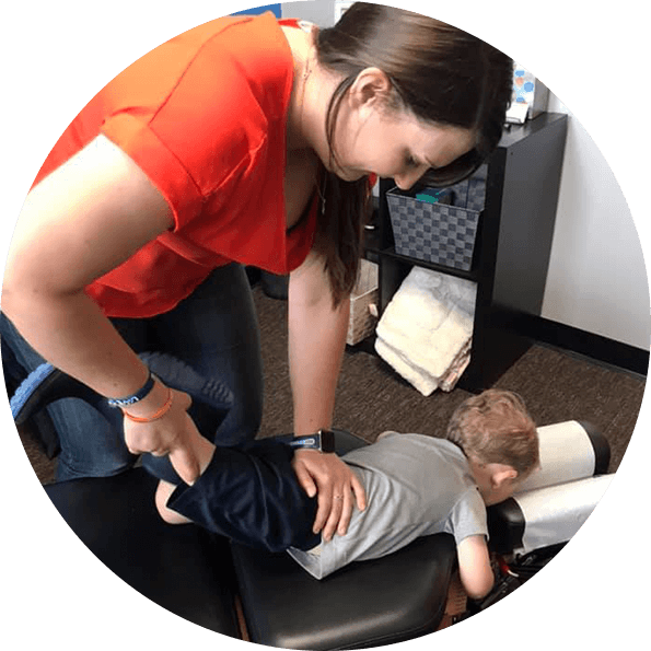 Dr. Lindsey adjusting toddler boy's leg