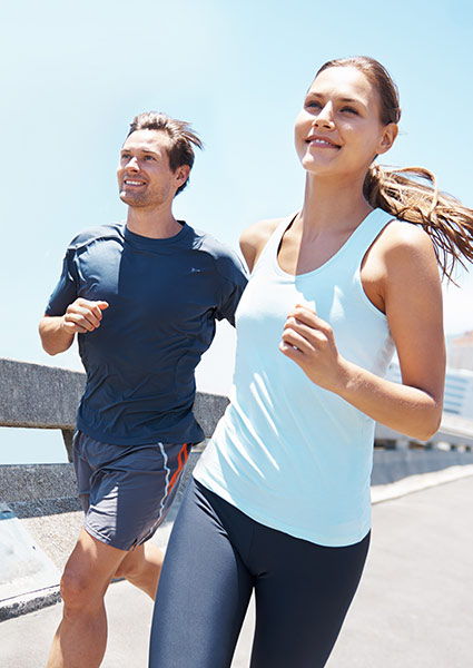 man and woman running on a sunny day