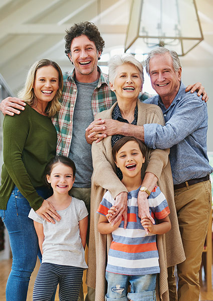 large multigeneration family smiling and hugging