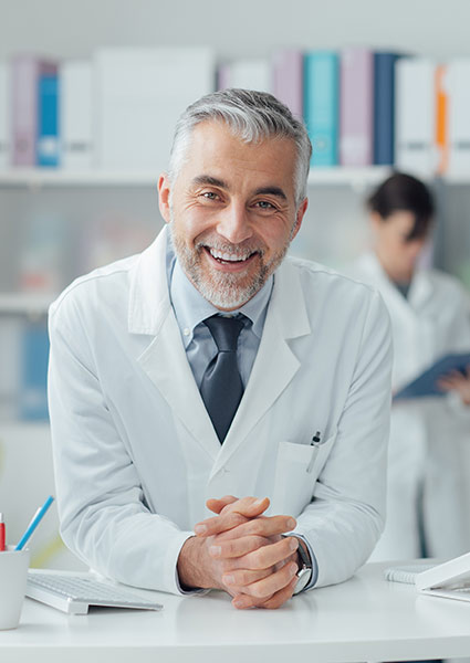 doctor smiling and standing at counter