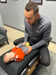 Dr. Nick adjusting a baby