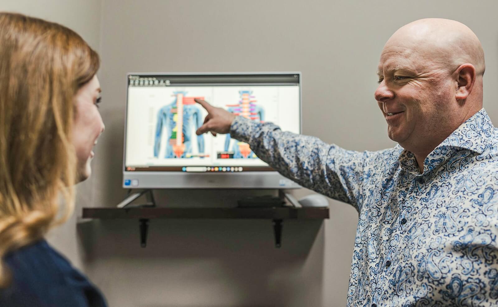 Stonebridge chiropractor Dr  Andy showing patient an x-ray
