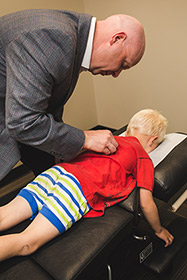 Dr. Pawlovich adjusting a child patient