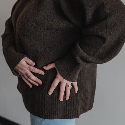 woman holding her hip in pain