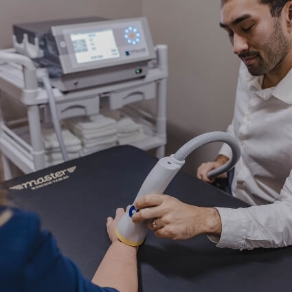 softwave treatment on persons wrist