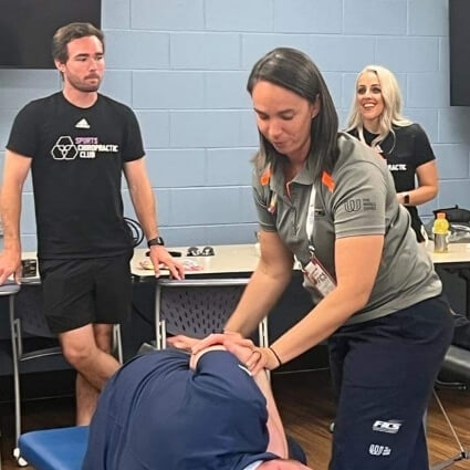 Dr Maggie adjusting patients back