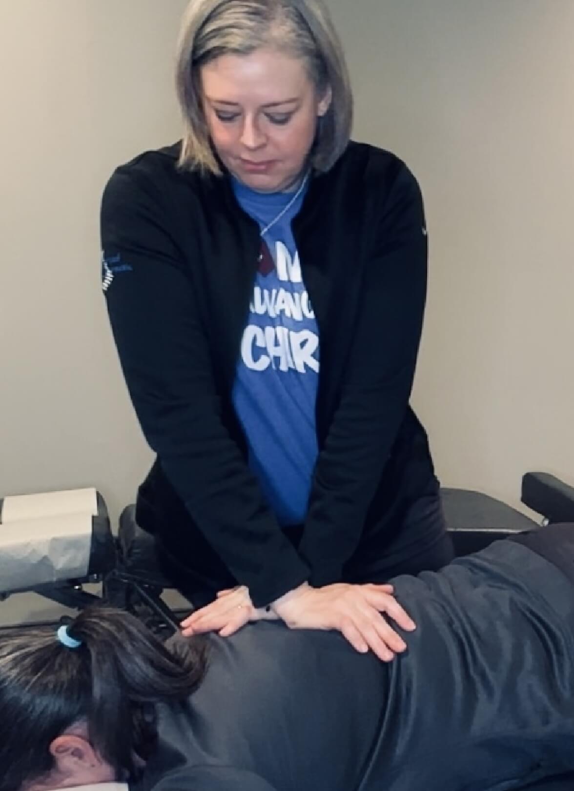Tallapoosa chiropractor Dr Angela adjusting patients back