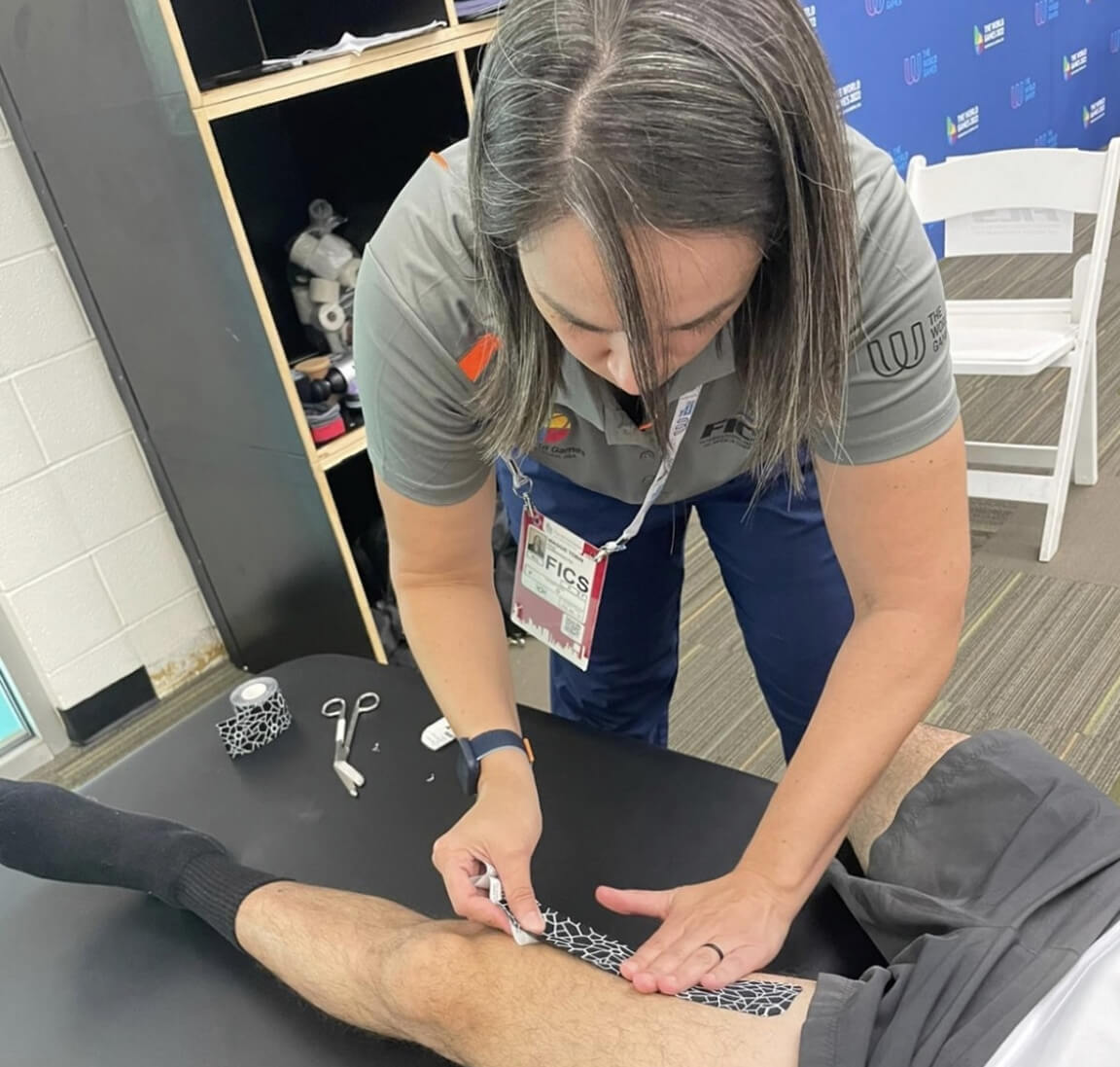 Tallapoosa chiropractor putting kinesio tape on persons knee