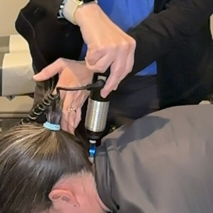 patient having neck adjusted with tool