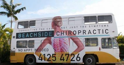 Double decker bus with Beachside Chiropractic info on it