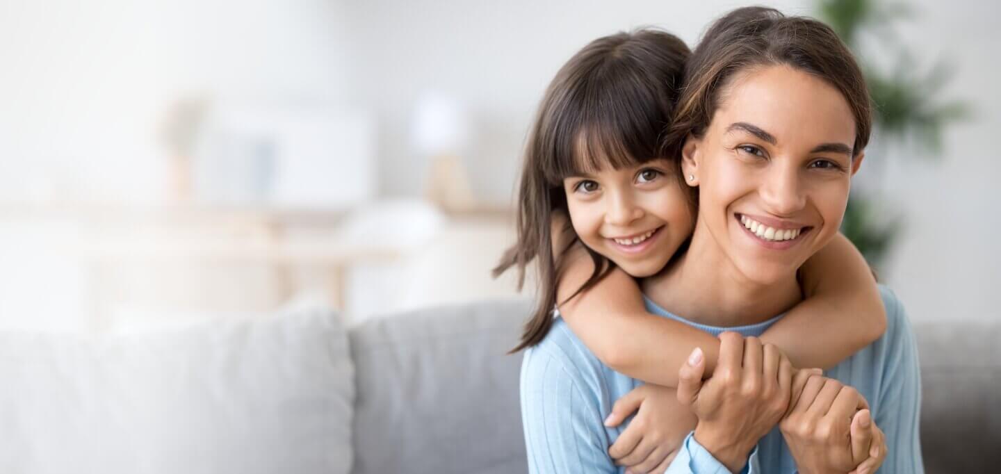 Mother and daughter smiling together