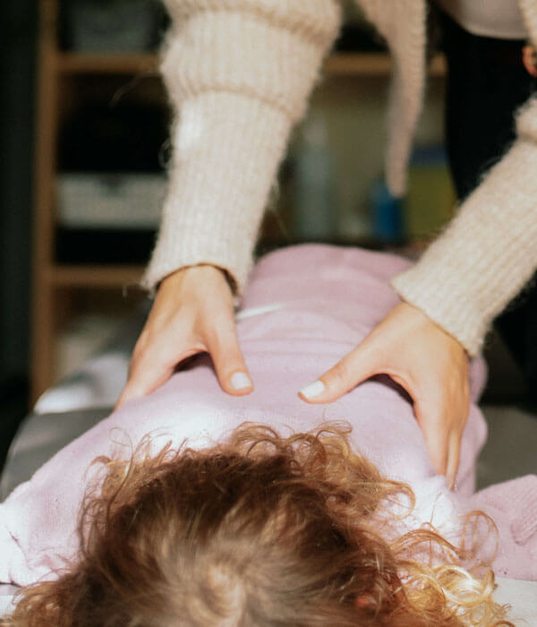 Chiropractor adjusting patients back