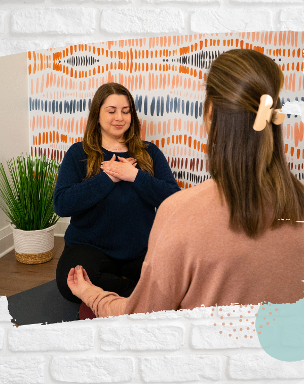 counselor sitting in chair with hands crossed over heart