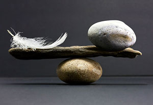 feather and rock balancing