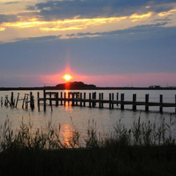 Sun setting at a pier.