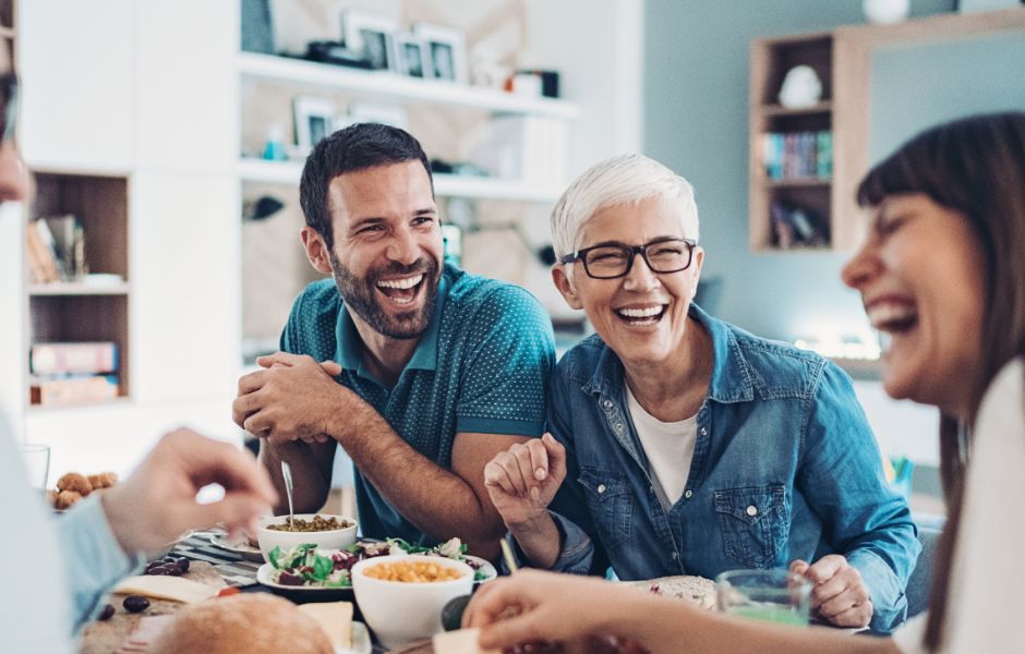 Multi-generational family laughing at dinner