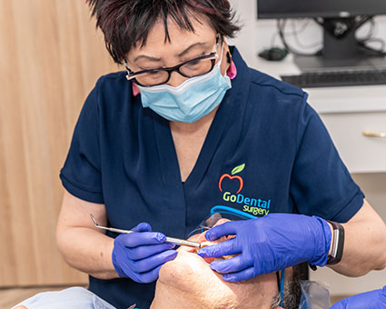 Dentist cleaning patient