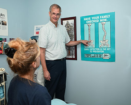 Dr. Christel pointing to spine model