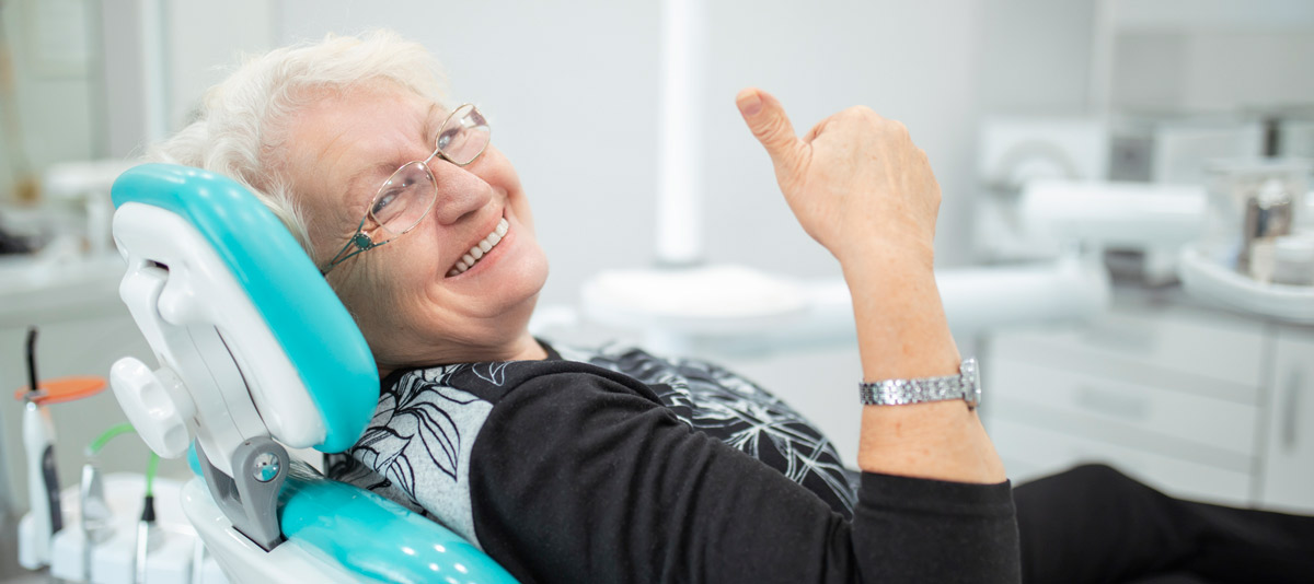 woman-sitting-in-dental-chair-smiling