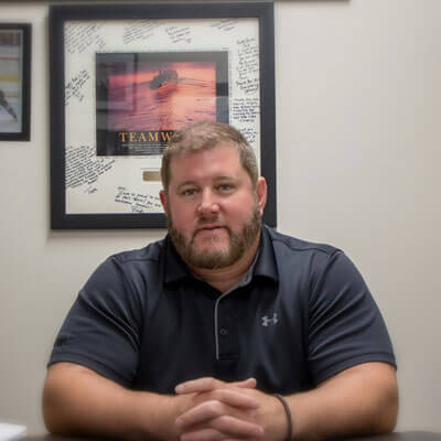 Chiropractor Newington, Dr. Eric sitting at desk