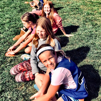 School kids sitting on the grass