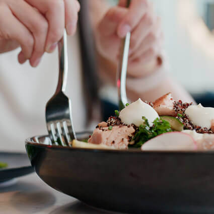 person-serving-themselves-healthy-food-from-a-large-bowl-sq