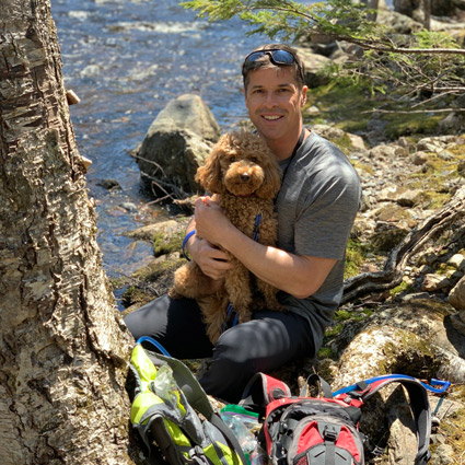 Dr. Mike hiking with dog