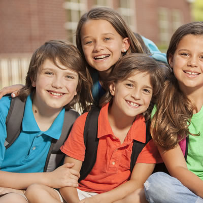 school children wearing backpacks