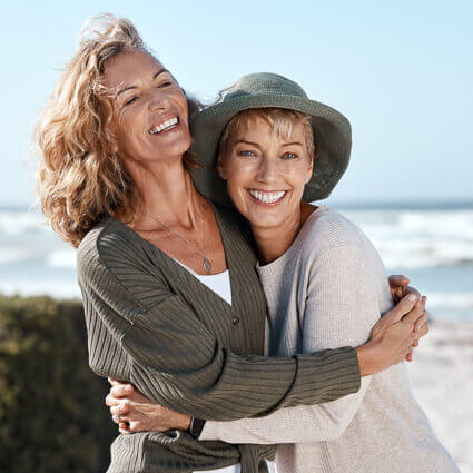 smiling women outdoor embracing
