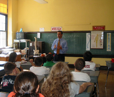 Dr Shire stands in front of class