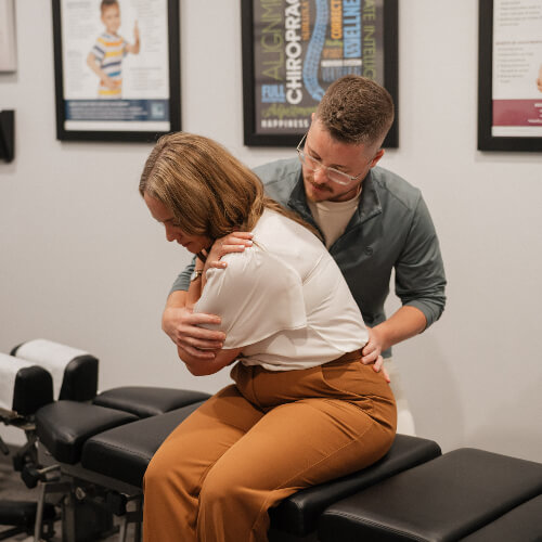 Female patient receiving a chiropractic adjustment