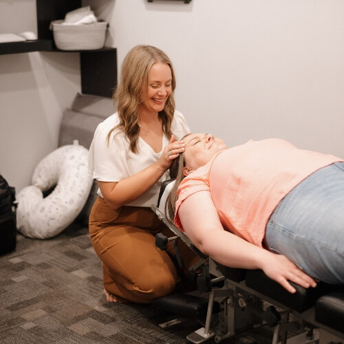 Johnston patient receiving a cranial adjustment
