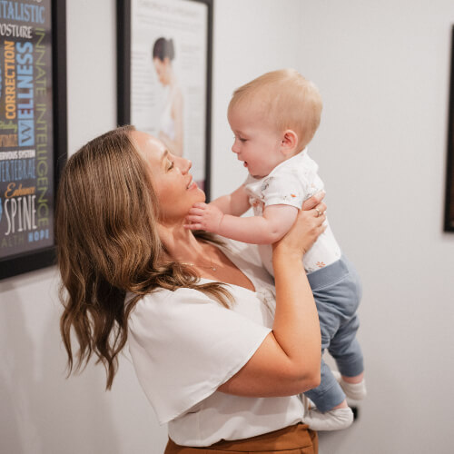 Chiropractor holding a baby