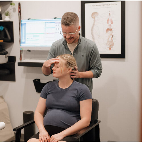Chiropractor adjusting patient's neck
