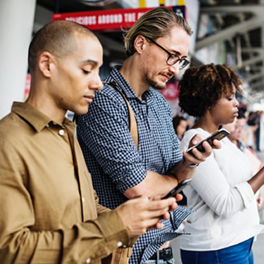 people standy by using mobile phones