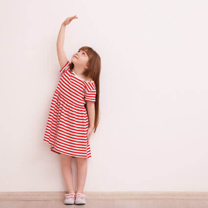 little-girl-imagining-growing-tall-sq