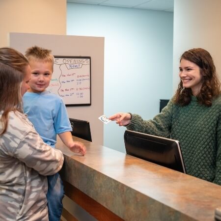 Patients checking in at front desk