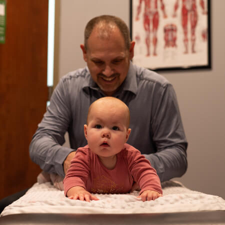 Baby receiving a chiropractic adjustment