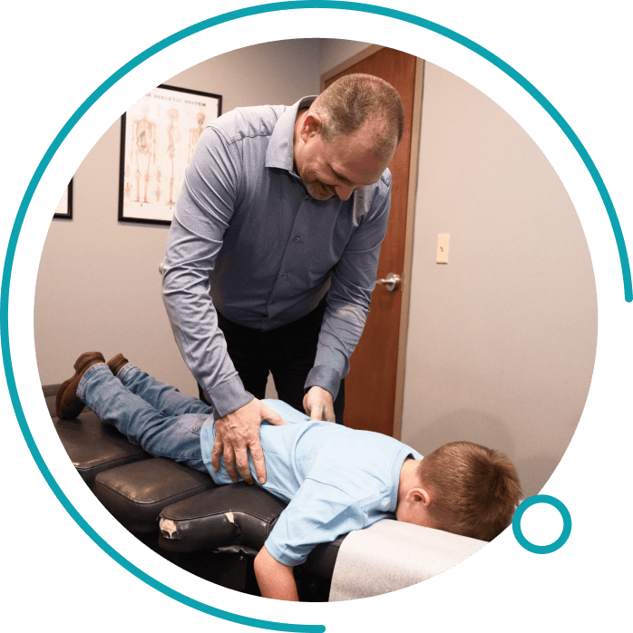 Chiropractor adjusting kid patient