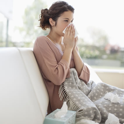 young woman on couch with flu