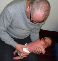 Sturgeon Bay pediatric chiropractor adjusts newborn.
