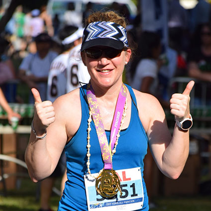 person with thumbs up after a marathon