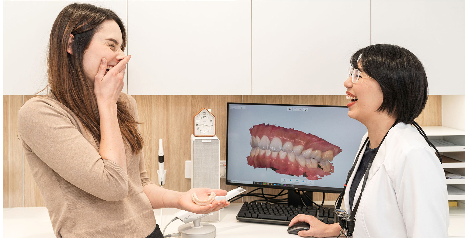 Patient and dentist laughing