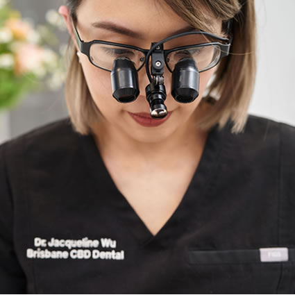 Dr Jacqui Wu wearing magnifying glasses