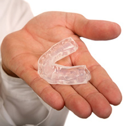 person holding mouthguard