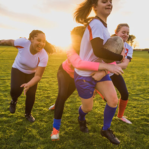 Young girls playing rugby