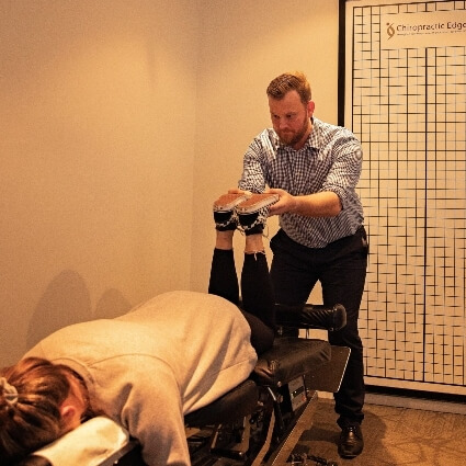 Chiropractic Edge patient having legs adjusted