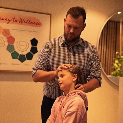 Pukekohe chiropractor Dr Christ adjusting child